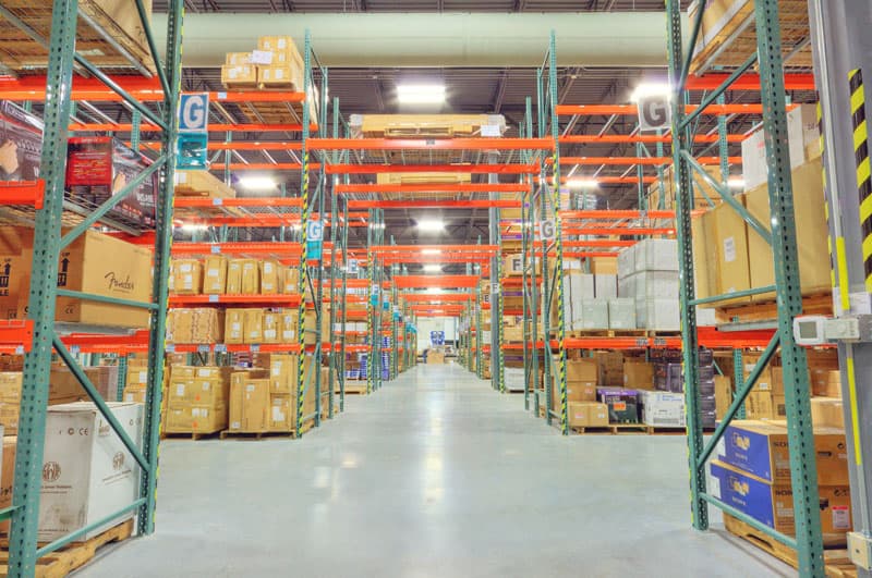 a large industrial warehouse with a steel frame structure, featuring a corrugated metal facade and multiple loading bays