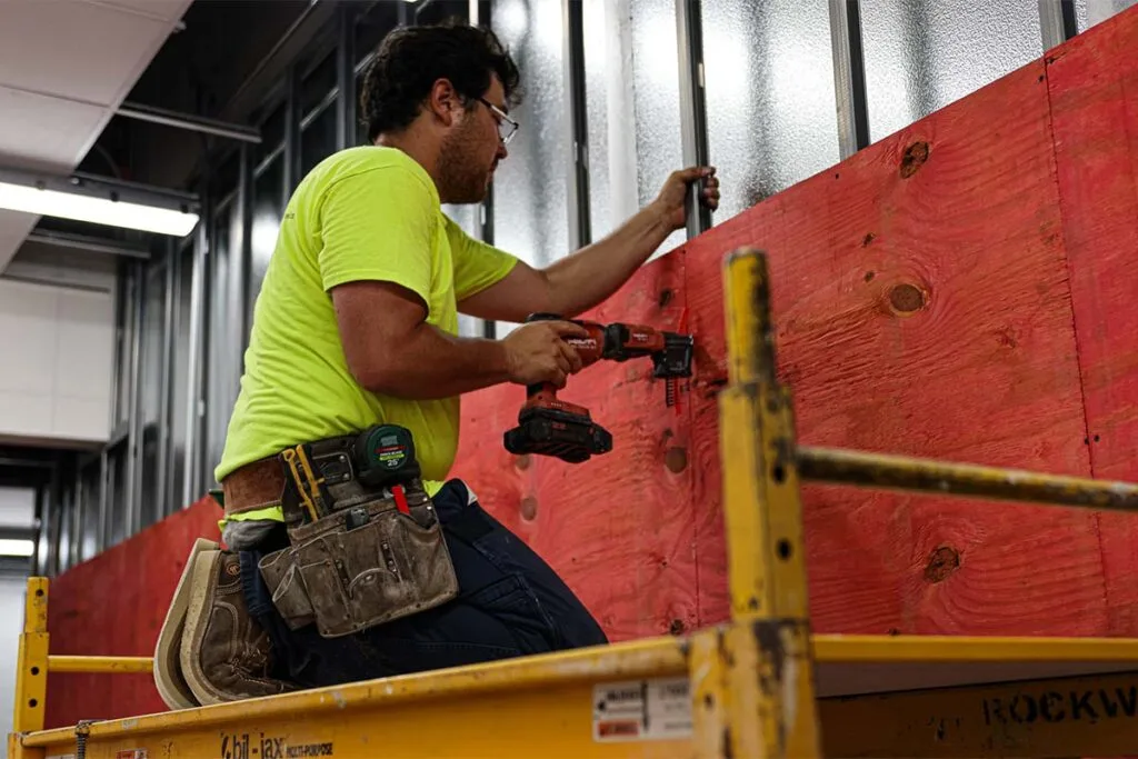 a Fox Arneson worker building a wall