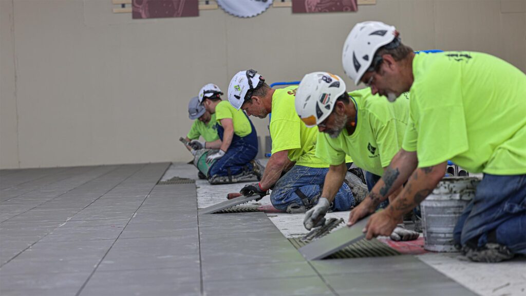 construction workers assembling floor tiles